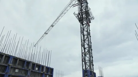 Tower crane at construction site of high-rise concrete building structure Stock Footage 318779659