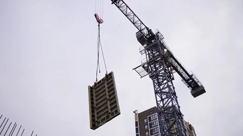 Tower crane at construction site moves cargo Video stock 254511758