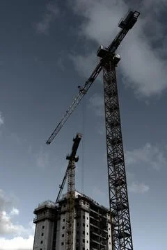 Tower crane at the construction site of a multi-storey residential building Stock Photos