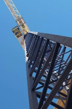 Tower crane at construction site. Narrow view from below Stock Photos