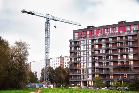 Tower crane at a construction site for a new residential building. Nearby c.. Stock Photos