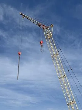 Tower crane - design for construction, in the blue sky Stock-Fotos