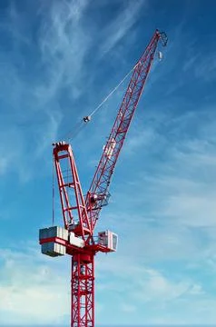 Tower crane high in sky at construction site Stock Photos