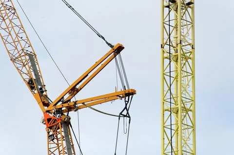 Tower crane high in sky at construction site Stock Photos