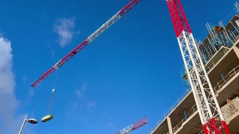Tower crane lifting a container on a construction site Stock-Footage 326092488