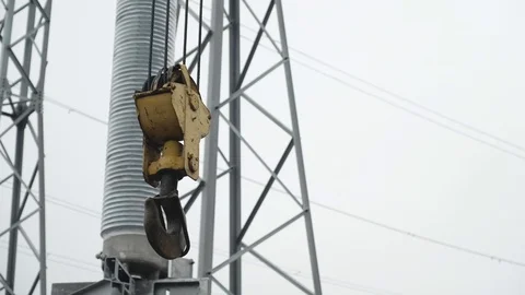 Tower crane lifting hook detail against cloudy sky at construction site. Stock Footage 124886879