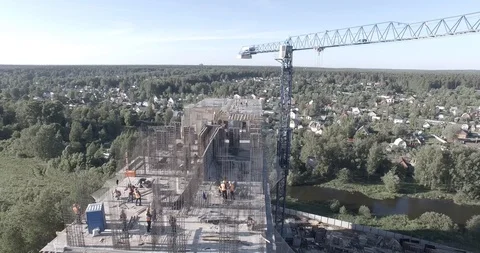 Tower crane lifts the load on multistory residential building under construction Stock Footage 105080193