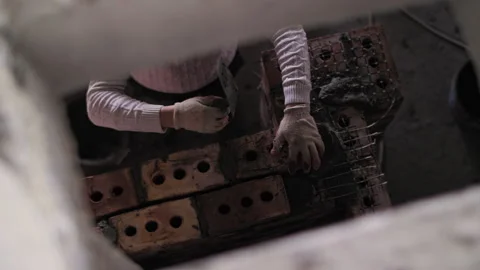 Tower crane moves cargo at a construction site against the sky Stock Footage 244848194