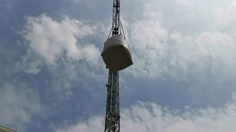 Tower Crane Moves a White Big Bag at Building Site Stock Footage 144608588