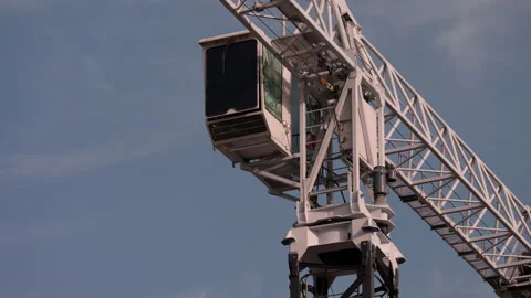 Tower crane operator cabin and lattice boom against blue sky Stock-Footage 344471482