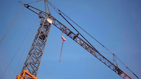 Tower crane operator at work on a high-rise construction site. View of the crane Stock Footage 325994739