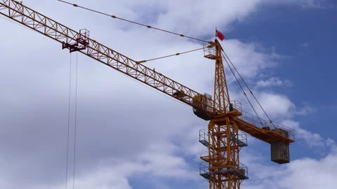 Tower Crane Rotating Against Blue Sky with Mongolian Flag at Construction Site Video stock 348047218