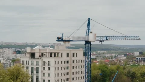 Tower crane rotating over a city construction site timelapse Stock Footage 345519117