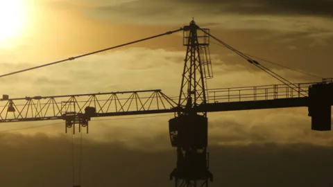 Tower crane silhouette in backlit from shining fog Stock Footage 116874469