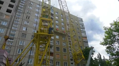 Tower crane standing beside a multi-storey residential building, renovation Stock-Footage 346804529
