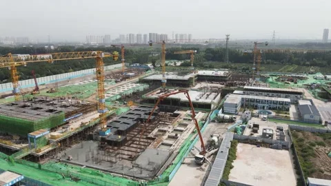 Tower crane workers in urban construction real estate construction site Stock Footage 139571413