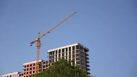 Tower crane working on building construction site Stock Footage 336358291