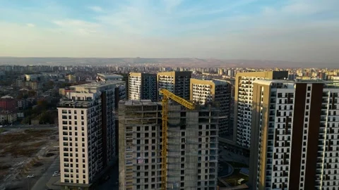 Tower crane working on a multi-story construction site 動画素材 292118996