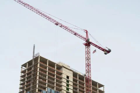 Tower cranes in action view of a large construction site with buildings under Stock Photos
