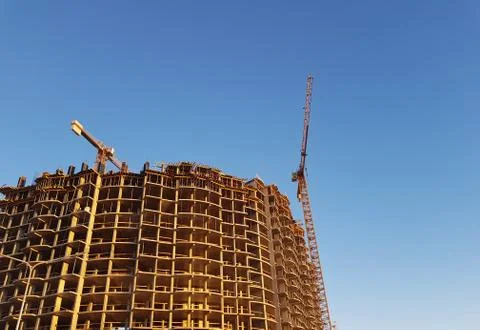 Tower cranes but against backdrop of construction Stock Photos