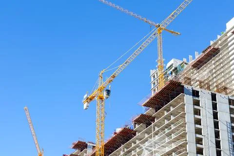 Tower cranes and building construction site Stock Photos