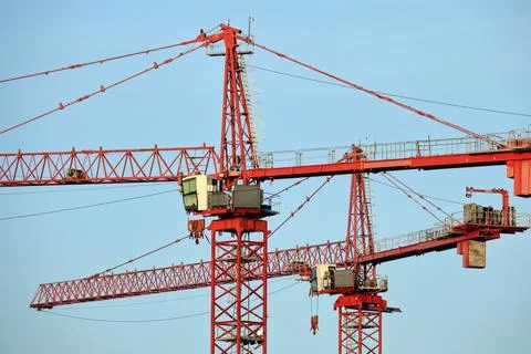Tower cranes and frame structure of high residential apartment buildings at Stock Photos