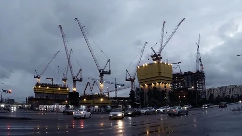 Tower cranes and intersection in the center of Astana in the evening in cloudy Stock Footage 81795047