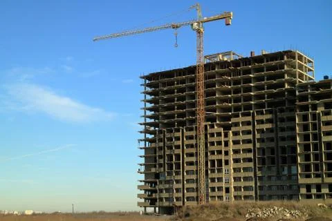 Tower cranes are working on the construction of a new house. Lifting crane. Stock Photos