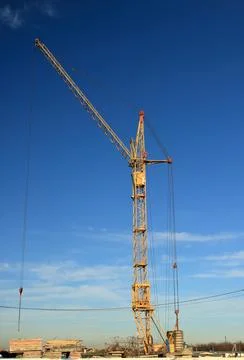 Tower cranes are working on the construction of a new house. Lifting crane. Stock Photos
