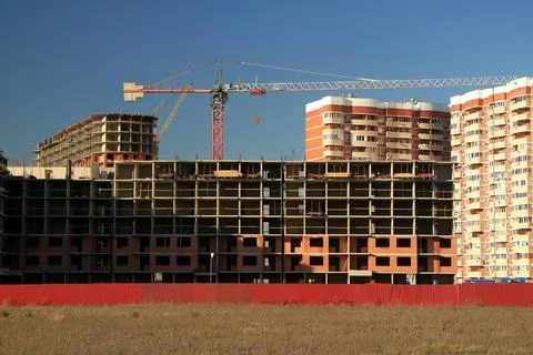 Tower cranes are working on the construction of a new house. Lifting crane. A Stock Photos