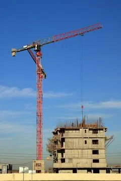 Tower cranes are working on the construction of a new house. Lifting crane. Stock Photos