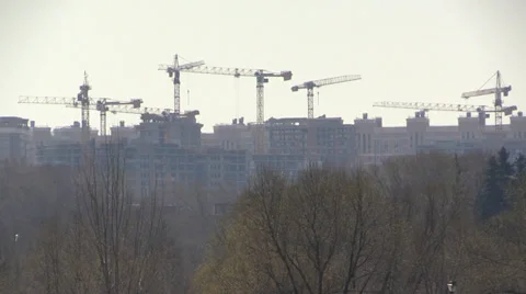 Tower cranes on a background of urban development and nature park Stock Footage 37284273