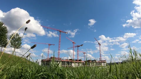 Tower cranes construct or build plant in the city. Side view timelapse Stock Footage 114189889