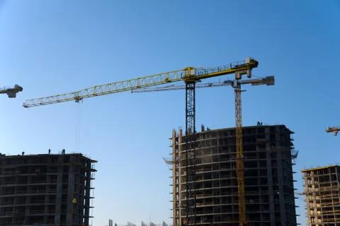 Tower cranes constructing a new residential building at a construction site a Foto stock
