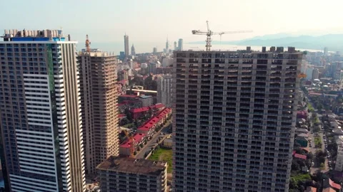 Tower Cranes on a Construction Site on clear blue day aerial view. Builders w Stock Footage 205898146