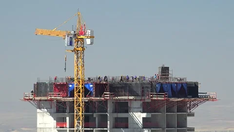 Tower cranes construction workers - Concrete Structure and Industrial Machinery Stock Footage 339646225