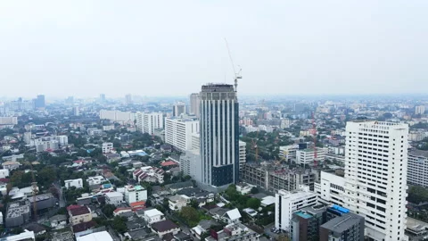 Tower cranes on the foreground, fog on the background. City skyline. Drone view Stock Footage 210812872