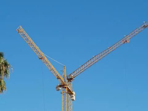 Tower cranes formed a letter V blue sky Stock Photos