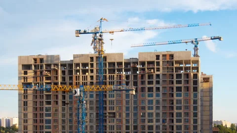 Tower Cranes Operating on Concrete Residential Building Site in Timelapse Video stock 343550483