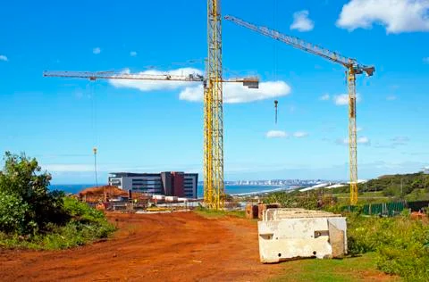 Tower cranes operating on construction site Stock Photos
