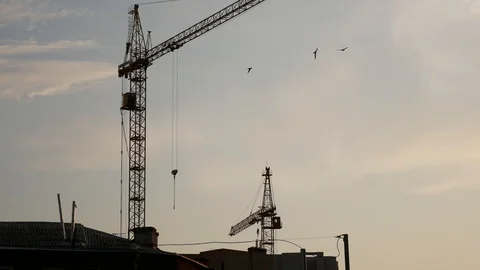 Tower cranes on the sky background at sunset Stock Footage 113742790
