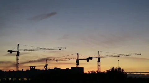  Tower cranes on a sunset background. Stock Footage 138456644