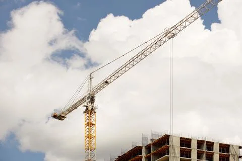 Tower cranes work during the construction of a multi-story building. New ap.. Stock Photos