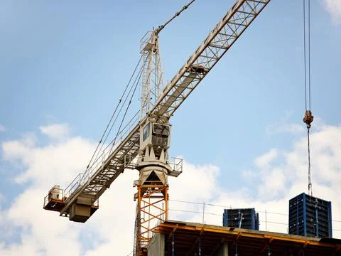 Tower cranes work during the construction of a multi-story building. New ap.. Stock Photos