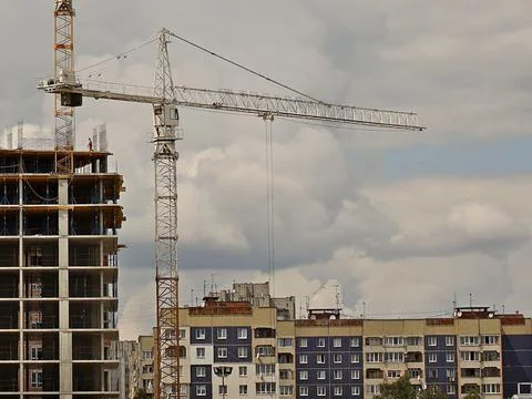 Tower cranes work during the construction of a multi-story building. New ap.. Stock Photos