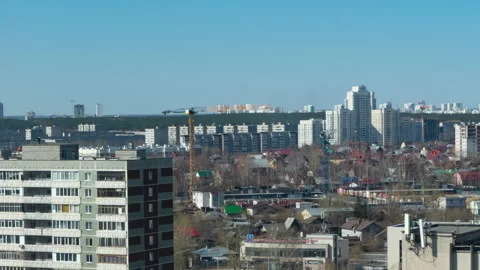 Tower cranes working at a construction site, cityscape on a sunny day Stock Footage 189775747