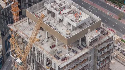 Tower cranes working on the construction site of new skyscraper high-rise b.. Stockfoto's