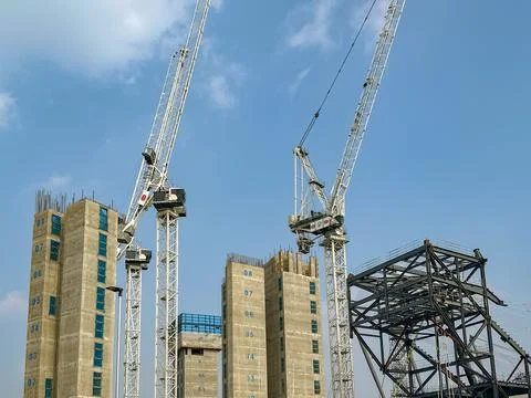 Tower cranes working on elevator shafts on a new development Stock Photos