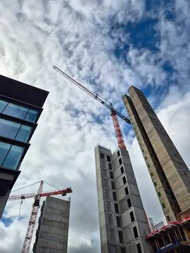 Tower cranes working on high rise construction site Stock Photos