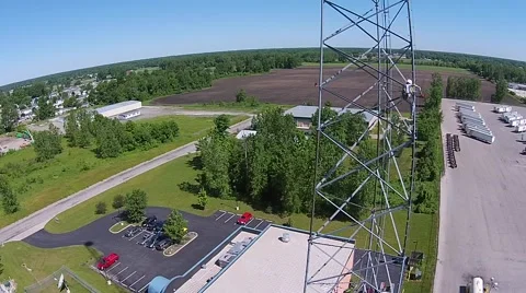 Tower crew changing side beacon bulb on side of broadcast tower - aerial view Stock-Footage 40366472